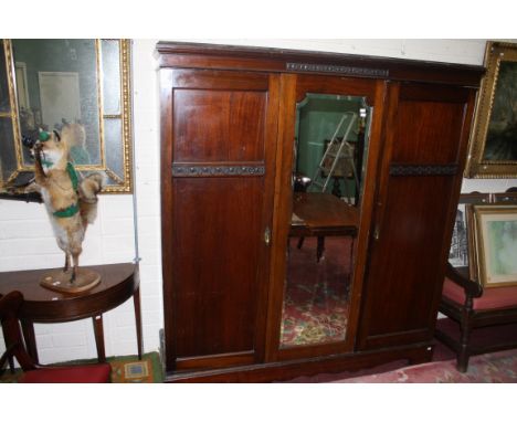 A THREE-DOOR MAHOGANY WARDROBE, 20th century with centre mirror panel, raised on bracket feet, 80in (204cm)h x 75in (191cm). 