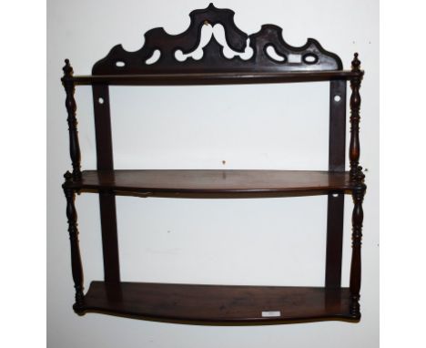 A VICTORIAN THREE TIER SERPENTINE SHAPED WALL BRACKET, with turned pillars, 26'' (66cm)w. (1)