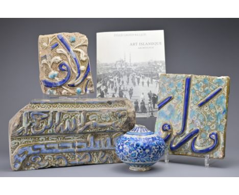 IRANIAN CERAMIC GLAZED TILES AND FRAGMENTS, 13TH CENTURY. To include two ceramic tiles decorated in relief with calligraphy a