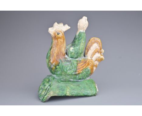 A CHINESE SANCAI GLAZED PORCELAIN ROOF TILE, QING DYNASTY. In the form of a man on rooster. 19cm height.Loss to tip of rooste