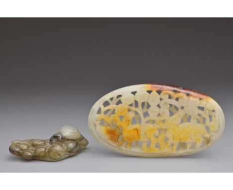 TWO CHINESE JADE ITEMS. To include an oval form pendant with pierced decoration of deers. Together with a grasshopper on pome