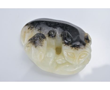 A CHINESE PALE CELADON AND BLACK JADE CARVING OF TWO CATS. In the form of two reclining cats coiled around each other. 4.5cm 