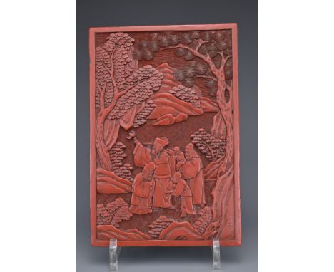 A CHINESE CINNABAR LACQUER PANEL, 19TH CENTURY. Well carved in relief with scholar figures in a landscape scene. 22cm x 15cm 