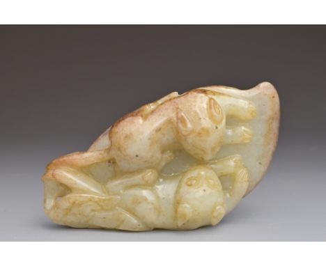 A CHINESE CELADON AND RUSSET JADE PENDANT OF TWO CATS ON A LEAF. 9.5cm lengthOverall good general condition without damage or