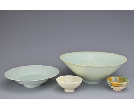 FOUR CHINESE CERAMIC CUPS AND BOWLS. To include a Chinese Qingbai glazed conical bowl with cared interior decoration. A Qingb