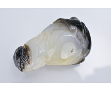 A CHINESE WHITE AND BLACK JADE PENDANT OF MONKEY AND BAT ON MELON. 4.5cm length Overall good general condition.