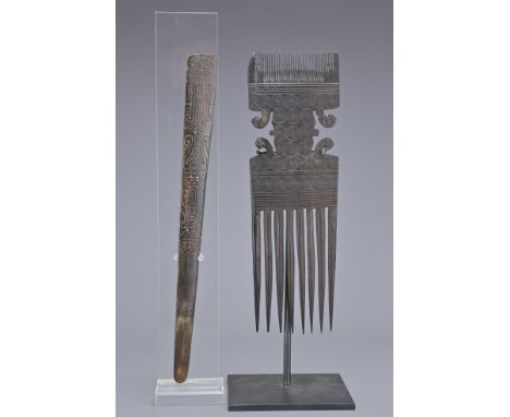 AN AFRICAN SWAHILI CARVED WOODEN TRIBAL COMB AND PAPUA LIME SPATULA. Finley carved with concentric circles between bands of h