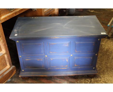 Modern blue painted panelled trunk with hinged cover, brass carrying handles and turned bun supports, 53cms high x 80cms wide
