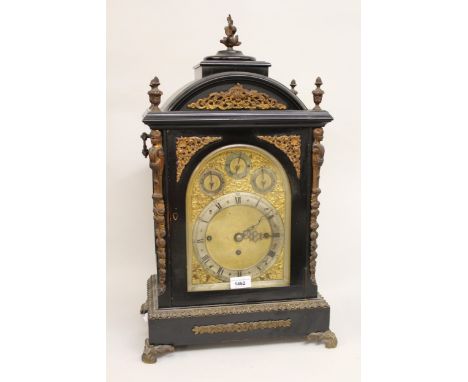 Edwardian ebonised and gilt brass mounted musical bracket clock, the broken arch case with five finial surmount and canted co