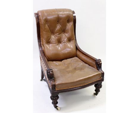 Victorian carved mahogany and button leather upholstered drawing room chair, the mask head carved scroll shaped arms above tu