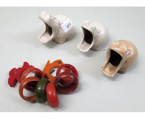 Group of three Wilkinson hippo form ashtrays, two Bakelite napkin rings and six other napkin rings 