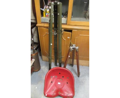 Early 20th Century red painted tractor seat, together with a military adjustable green painted tripod and another wooden adju