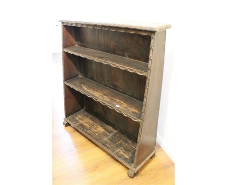 Oak open three shelf open tapering bookcase with carved decoration on low supports, 98cm high x 92cm wide x 30cm deep 