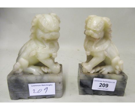 Pair of Chinese carved soapstone scroll weights in the form of temple dogs, 12.5cms high 