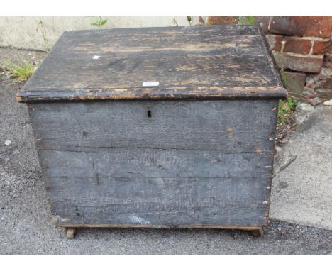Small 19th Century stained pine trunk with a hinged cover and two iron side handles, 64cms x 47cms x 50cms high 