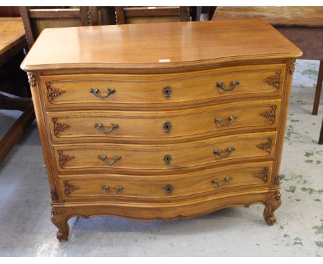 20th Century French walnut commode, the moulded top above four serpentine shaped drawers with carved floral decoration and br