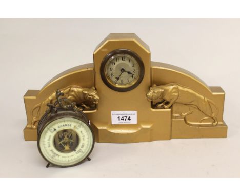 Art Deco gold painted metal mantel clock mounted with two figures of mountain lions, 32cms wide together with a small brass c