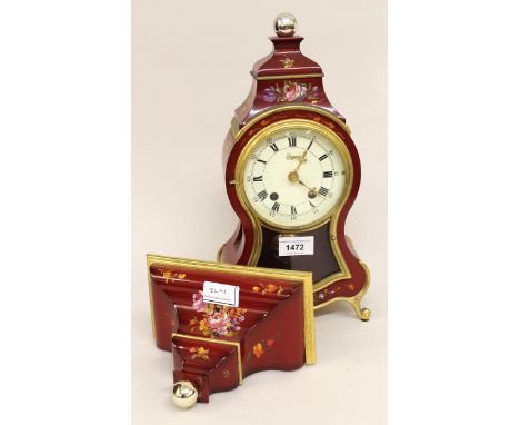Modern reproduction red lacquer decorated two train mantel clock with matching bracket, 48cms high overall 