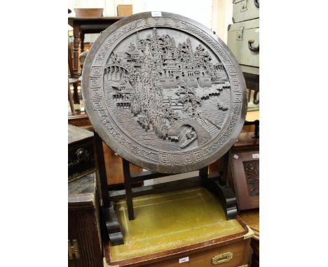 Chinese circular tilt-top occasional table with carved decoration (lacking glass top), together with a matching standard lamp