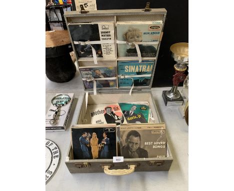 A VINTAGE RECORD DISPLAY CARRY CASE CONTAINING ASSORTED SINGLES 