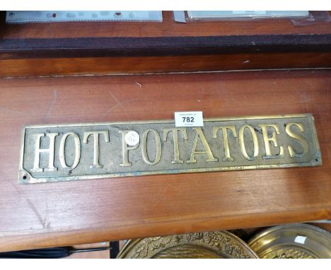 A VINTAGE BRASS 'HOT POTATOES' SIGN 