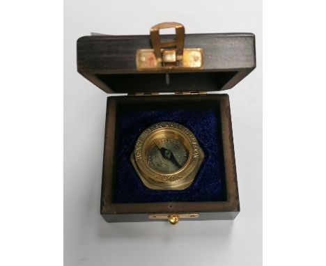 A WOODEN CASED BRASS COMPASS 