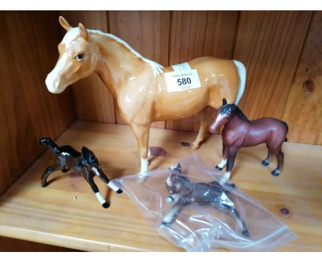 FOUR BESWICK CERAMIC HORSE MODELS - PALOMINO HORSE, AND THREE FOALS, ONE A/F 