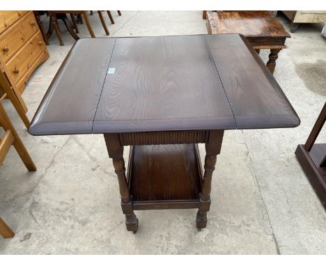 AN ERCOL STYLE DROP LEAF ELM TEA TROLLEY 