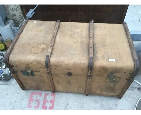 A VINTAGE TRAVEL TRUNK WITH LEATHER SIDE HANDLES AND INNER TRAY 
