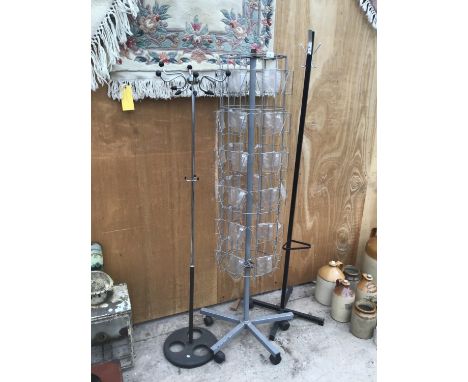 TWO BLACK MODERN COAT STANDS AND A ROTATING CARD STAND 