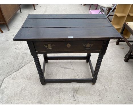 AN 18TH CENTURY OAK LOWBOY ON BOBBIN ON TURNED SUPPORTS WITH PLANKED TOP AND SINGLE DRAWER WITH BRASS HANDLES AND LOCK PLATE 
