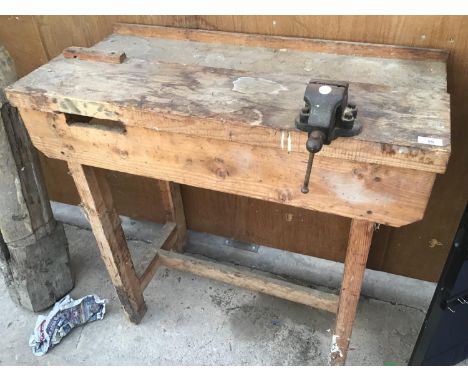 A WOODEN WORK BENCH WITH SMALL VICE NO.0 