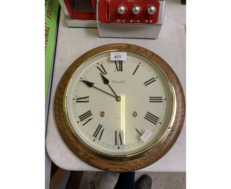 A CHURCHILL CIRCULAR CASED QUARTZ WALL CLOCK 