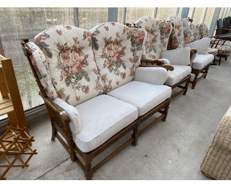 AN ERCOL OAK COTTAGE THREE PIECE SUITE COMPRISING A TWO SEATER SOFA AND TWO ARMCHAIRS 