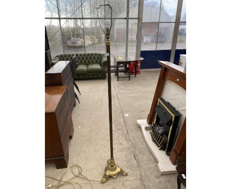 A HEAVY BRASS STANDARD LAMP ON TRIPOD SUPPORT 