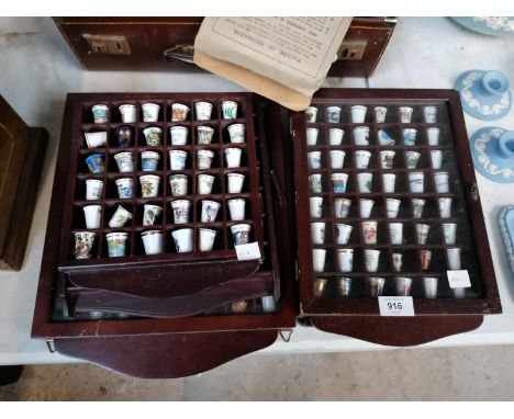 A LARGE COLLECTION OF CERAMIC THIMBLES IN DISPLAY CASES 