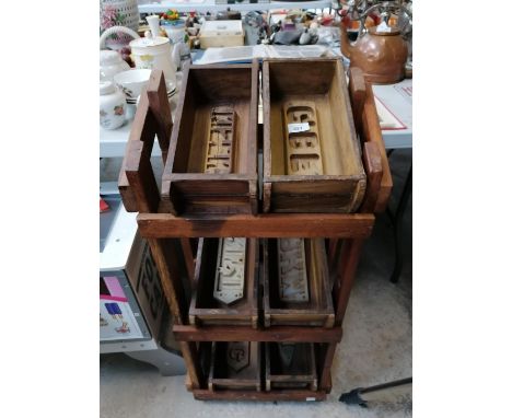 A WOODEN STAND WITH VINTAGE STYLE BRICK MOULDS 