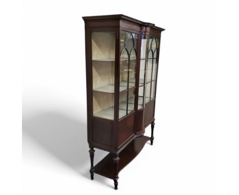 An Edwardian Sheraton Revival mahogany and satinwood inlaid bow centre display cabinet, astragal glazed doors, turned legs, s