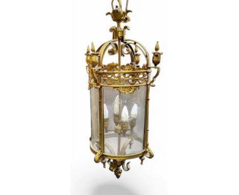 A 20th century gilt metal&nbsp; hall lantern, cast in the Baroque taste with leafy finials,&nbsp; scrolls and swags, etched g