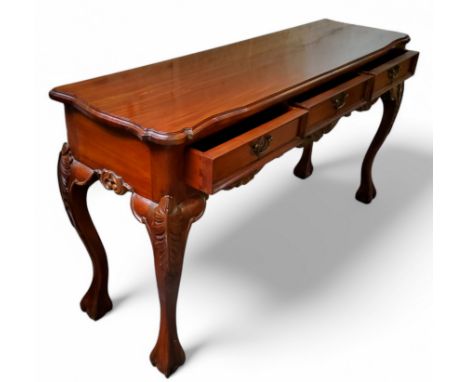 A Chippendale Revival mahogany sideboard, three drawers to frieze, carved apron, cabriole legs terminating with ball and claw