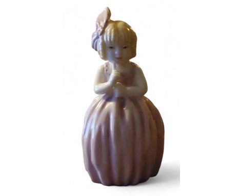 A Royal Worcester candle snuffer, Hush, modelled with a girl with her index finger held to her mouth, wearing a yellow and pi
