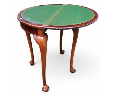 An Edwardian mahogany card table, the hinged top revealing green baize inset playing surface, the back leg fitted with playin