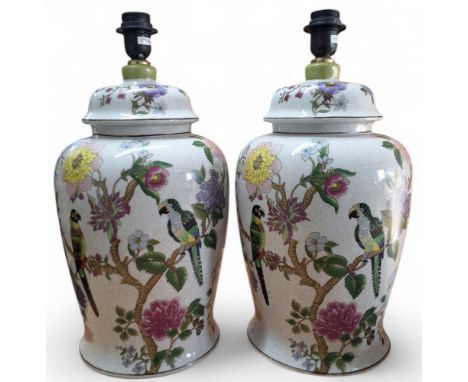 A pair of ceramic crackle glazed 'ginger jar' lamp bases, decorated with parrots amongst flowers and foliage, approx. 42 cms 