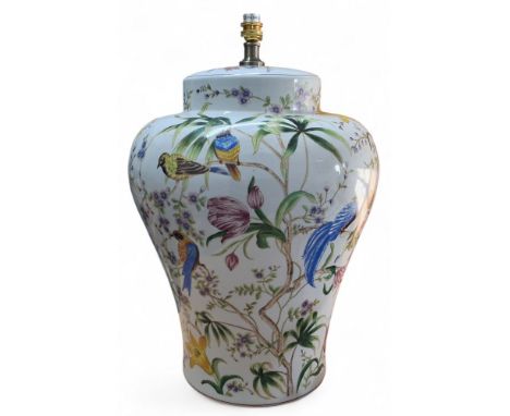 A large ceramic baluster shaped lamp base decorated with fanciful birds among foliage and wild flowers on a white ground, 49 