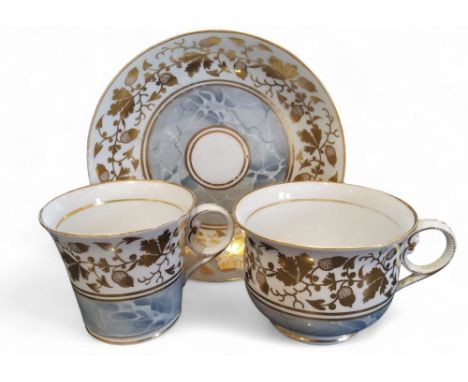 A Chamberlains Worcester coffee cup, teacup and saucer, banded with fruiting oak branches, above a marbled ground pattern 583