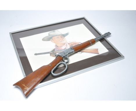 John Wayne framed print plus novelty replica rifle. 