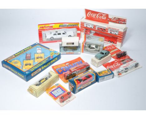 A group of older issue diecast to include Matchbox and Majorette plus Coca Cola promotional vehicles. Some packaging with sto