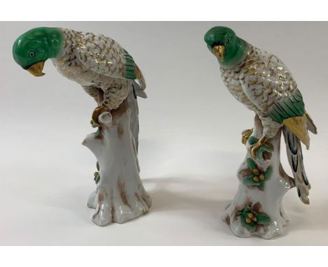 A pair of 19th century ceramic figures of birds, each painted with gilded and green highlights perched on tree stumps, 19cm h