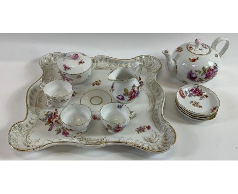 An early 20th century German tea service, comprising teapot, sugar, cream jug, serving tray, three cups and four saucers