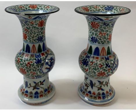 A pair of Chinese shaped vases, each decorated with a five clawed dragon either side, each with a Kangxi mark, 23.5cm high